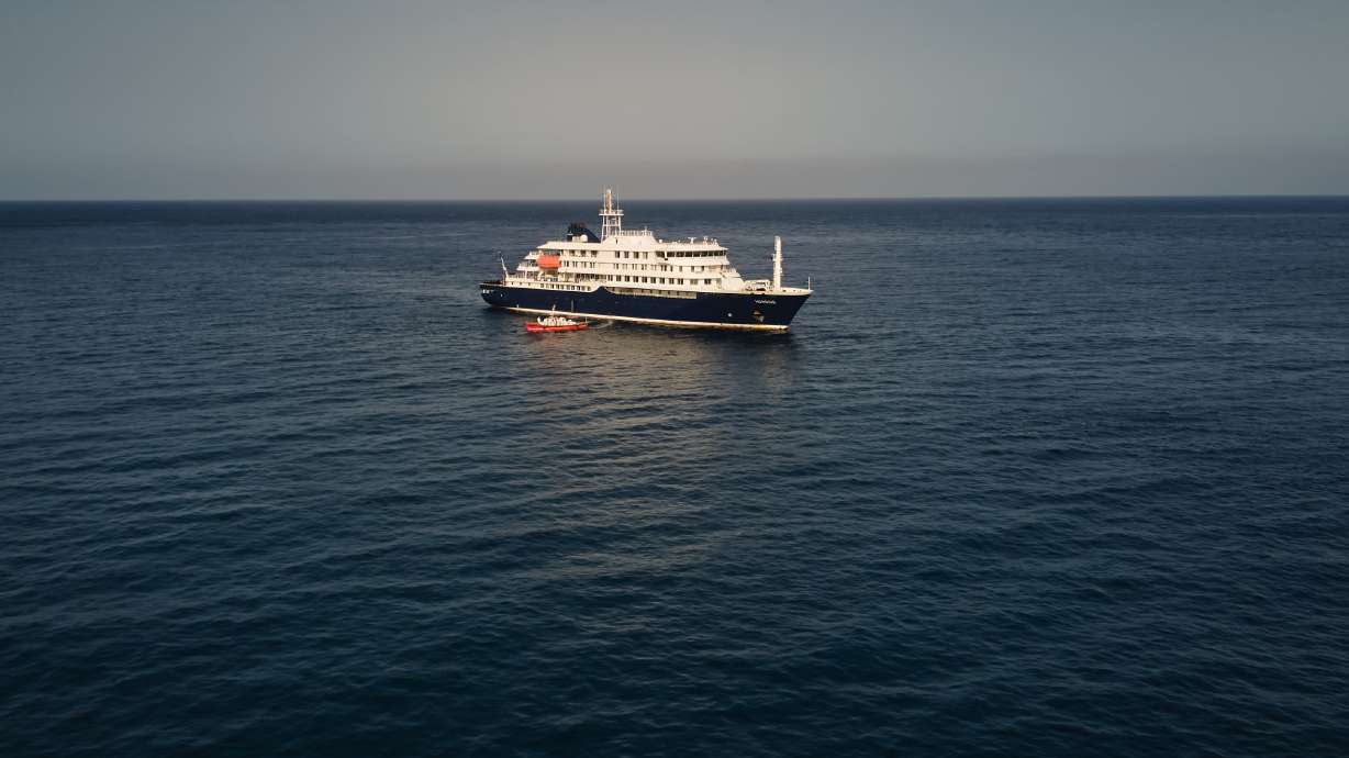 An aerial view of the MV Hondius Dutch cruise ship anchored in the Atlantic off Cape Verde, Tuesday. The U.N. health agency says three patients on a cruise ship with suspected hantavirus infections are being flown to the Netherlands.