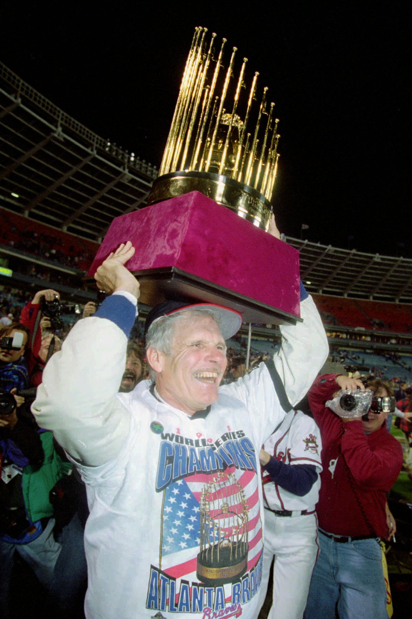 Atlanta Braves owner Ted Turner holds up the World Series trophy on the field at Atlanta Fulton County Stadium after the Braves won the 1995 World Series, Oct. 28, 1995, in Atlanta.