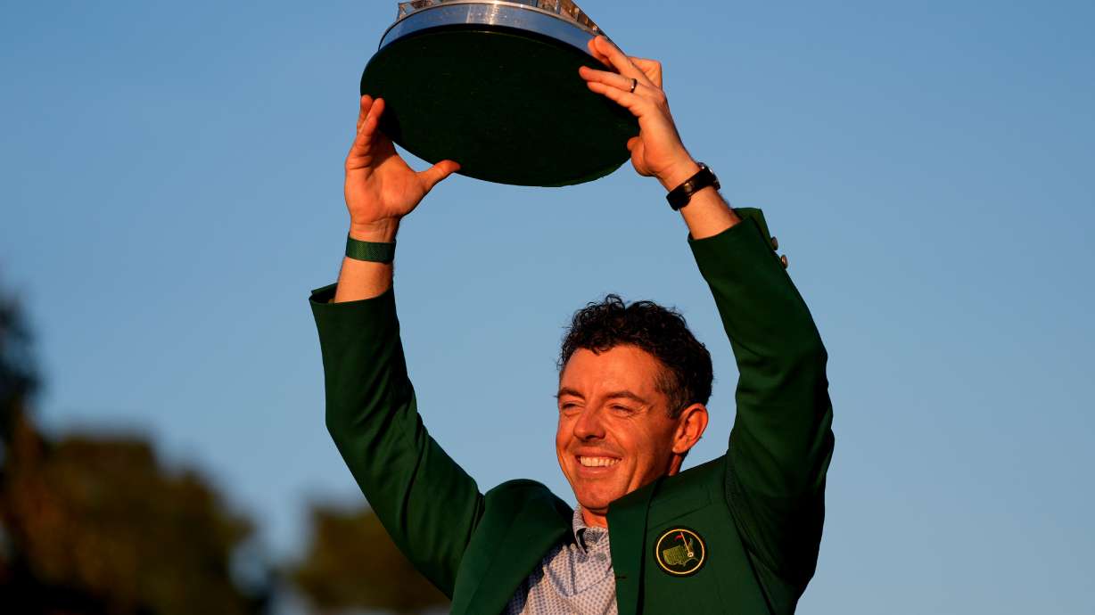 Rory McIlroy, of Northern Ireland, holds the trophy after winning the Masters golf tournament at the Augusta National Golf Club, Sunday, April 12, 2026, in Augusta, Ga.