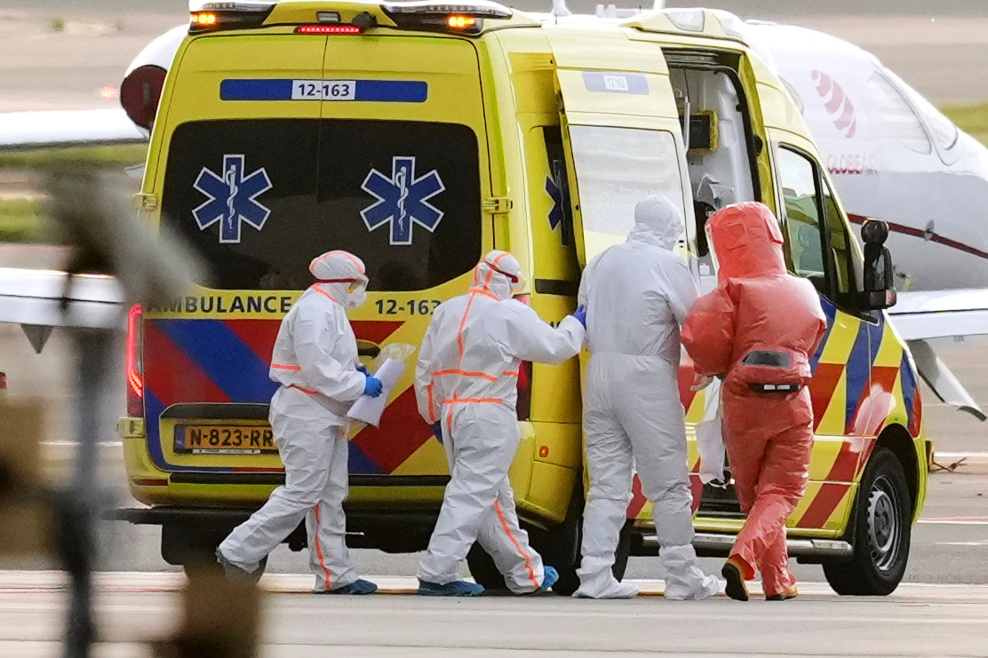 Medics escort a patient evacuated from the MV Hondius cruise ship with suspected hantavirus infection, to an ambulance after being flown to Schiphol airport, Amsterdam, Netherlands, Wednesday. The cruise ship is now headed for the Canary Islands.