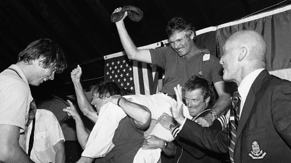 FILE - Ted Turner, center, is carried off by his crew following a news conference after his vessel Courageous won the Americas Cup sailing race, Sept. 19, 1977, in Newport, R.I. At right is Bill Ficker, skipper of cup winner Intrepid in 1970.