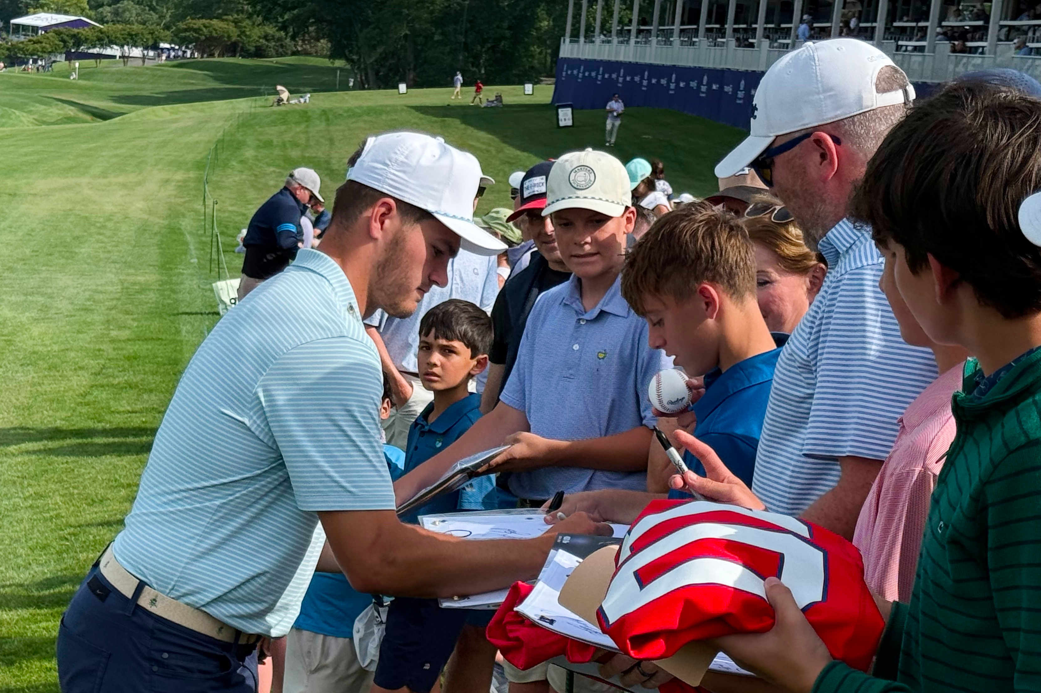 New England Patriots quarterback Drake Maye signs autographs for fans after the pro-am at the Trust Championship golf tournament, Wednesday, May 6, 2026, at Quail Hollow Club in Charlotte. 