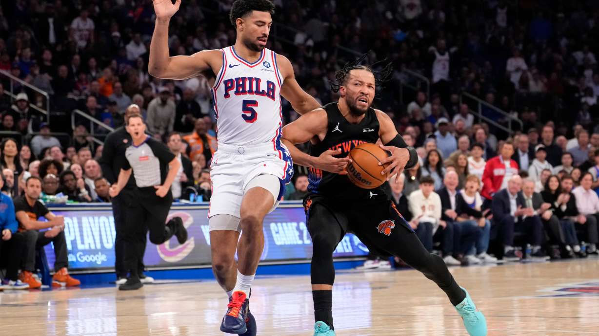 New York Knicks guard Jalen Brunson, right, drives past Philadelphia 76ers guard Quentin Grimes (5) during the first half of Game 2 in a second-round NBA basketball playoffs series, Wednesday, May 6, 2026, in New York.