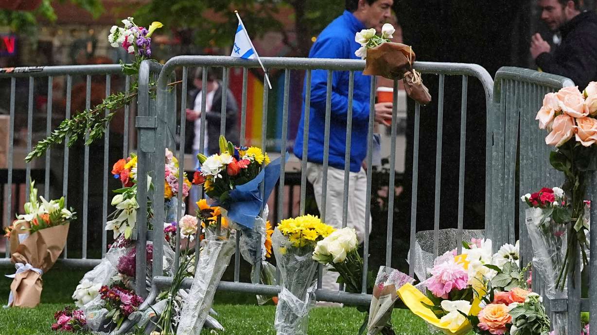 Bouquets of flowers stand along a makeshift memorial for victims of an attack outside of the Boulder County courthouse on June 3, 2025, in Boulder, Colo.