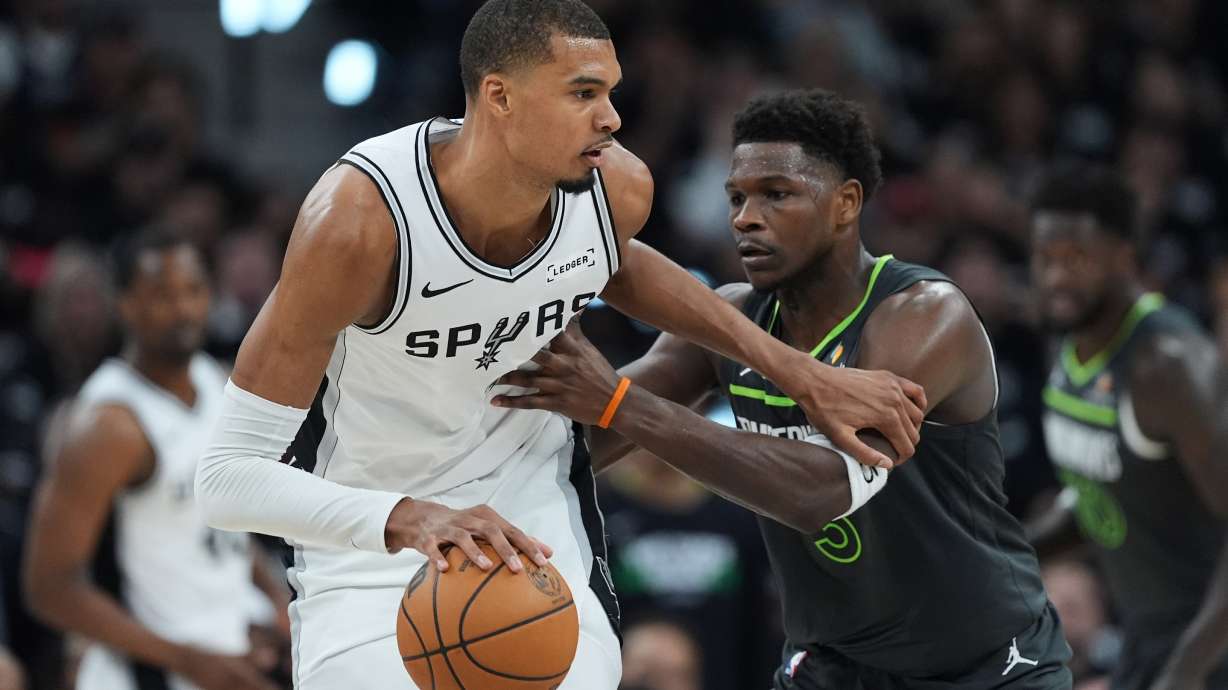 San Antonio Spurs forward Victor Wembanyama (1) drives against Minnesota Timberwolves guard Anthony Edwards (5) during the first half in Game 2 of a second-round NBA playoffs basketball series in San Antonio, Wednesday, May 6, 2026.