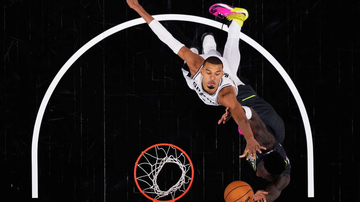 San Antonio Spurs forward Julian Champagnie, right, is blocked by San Antonio Spurs forward Victor Wembanyama, left, as he drives to the basket during the second half in Game 2 of a second-round NBA playoffs basketball series in San Antonio, Wednesday, May 6, 2026.