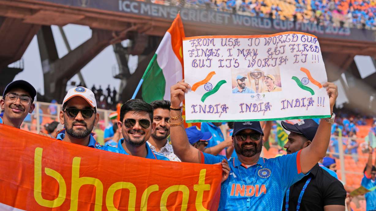 FILE - Indian cricket fans cheer holding banners and posters as they arrive at the stadium hours before the start of the ICC Men's Cricket World Cup final match between India and Australia in Ahmedabad, India, Sunday, Nov.19, 2023.