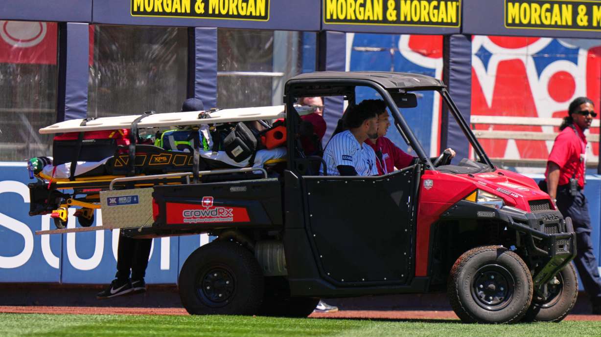 New York Yankees' Jasson Domínguez is carted off the field after an injury during the first inning of a baseball game against the Texas Rangers Thursday, May 7, 2026, in New York.