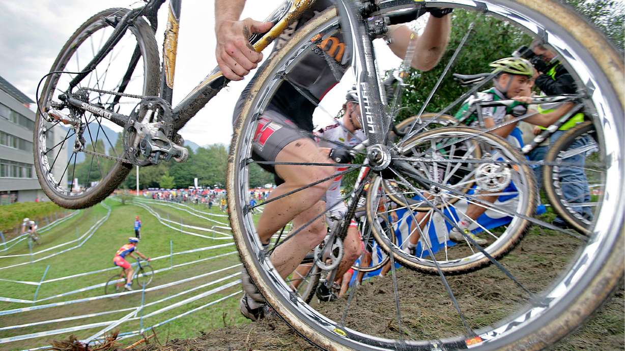 Riders climb a hill during the UCI Cyclo-Cross World Cup, Oct. 1, 2006, in Aigle, Switzerland. The International Olympic Committee ruled out the inclusion of summer sports like cyclocross at the Winter Olympics on Thursday, for now.