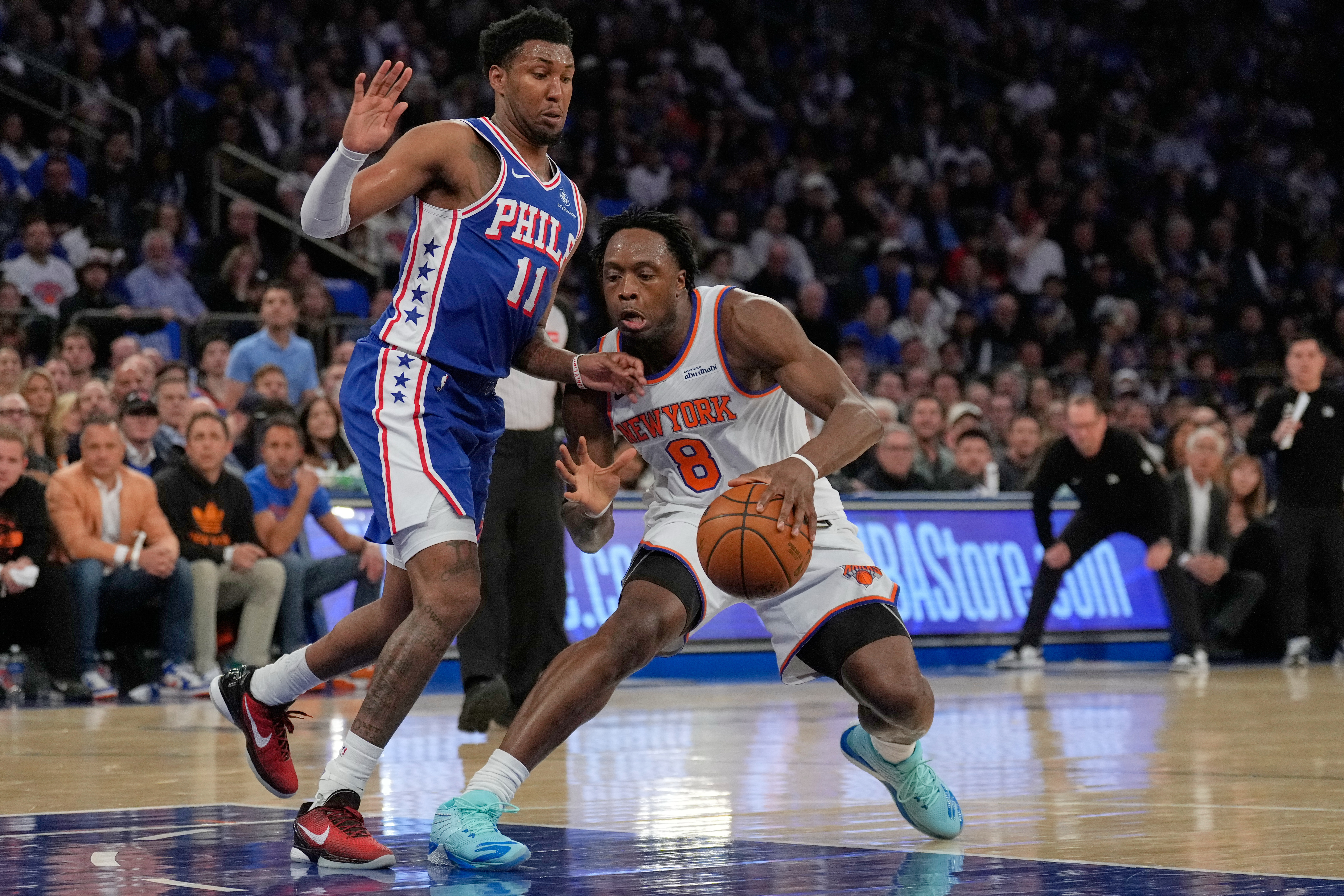 New York Knicks' Og Anunoby, right, drives past Philadelphia 76ers' Justin Edwards during the first half of Game 1 in a second-round NBA basketball playoffs series Monday, May 4, 2026, in New York. 