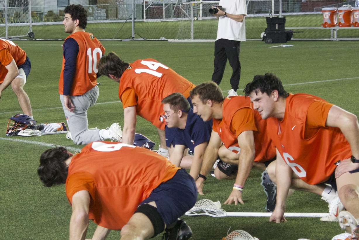 West Field junior Brady Famuliner stretches with the team after Utah Archers practice after Brady was honored as the Archers' honorary captain, Thursday, May 7, 2026 in Herriman, Utah.