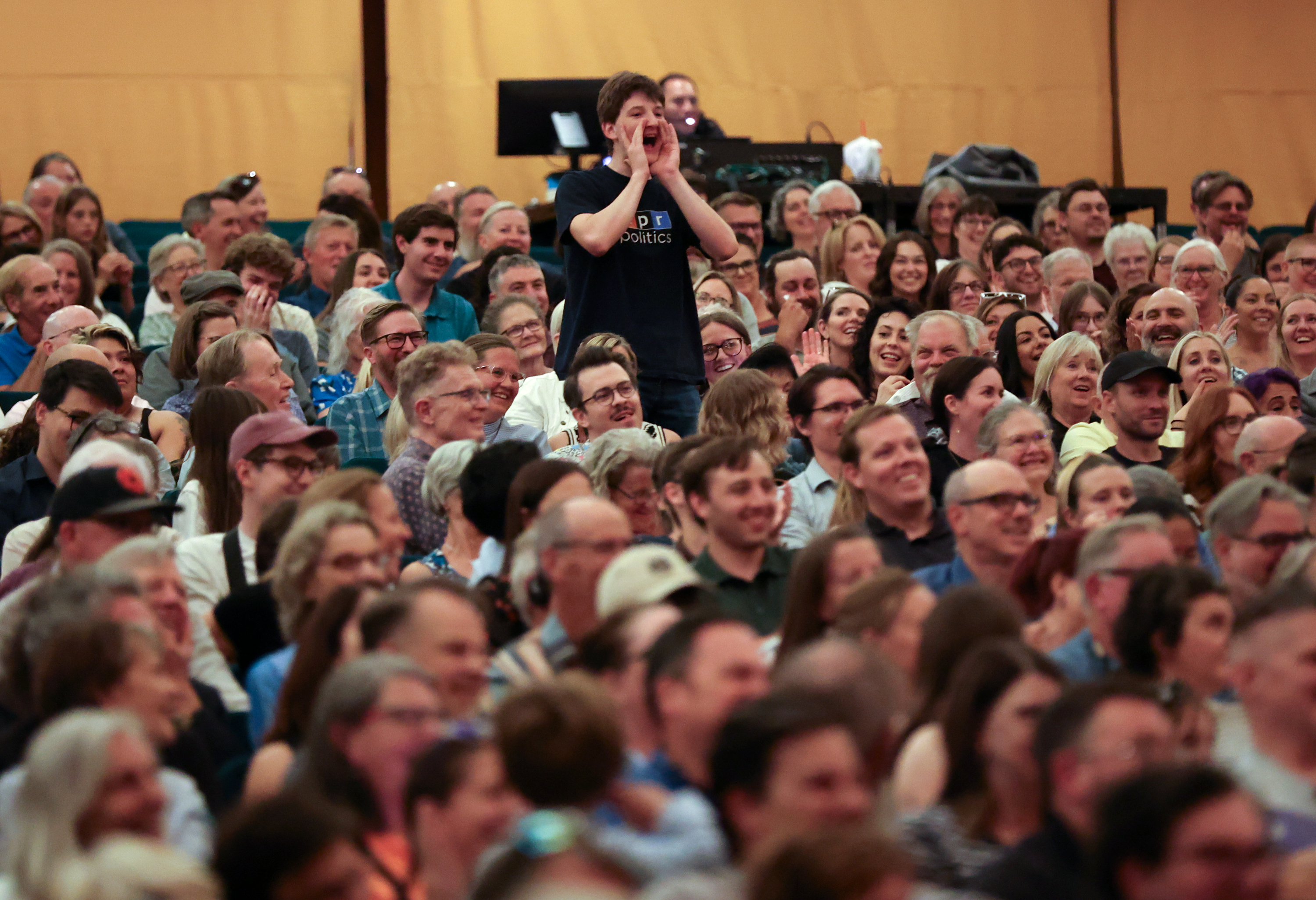 An audience member yells during a recording of the NPR news game show "Wait Wait... Don't Tell Me!" at Abravanel Hall in Salt Lake City on July 31, 2025. Sports and entertainment events at government facilities were considered for Salt Lake City's budget this year.