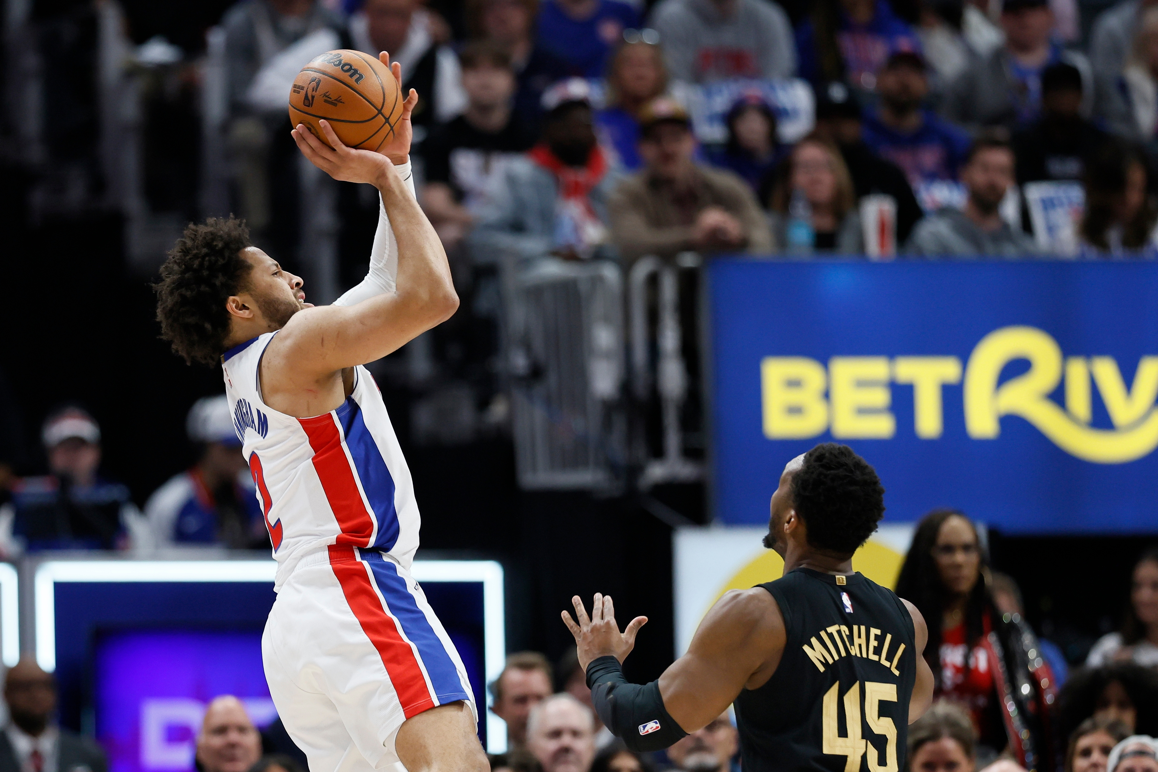 Detroit Pistons guard Cade Cunningham takes a shot against Cleveland Cavaliers guard Donovan Mitchell (45) during the first half in Game 2 of a second-round NBA playoffs basketball series, Thursday, May 7, 2026, in Detroit. 