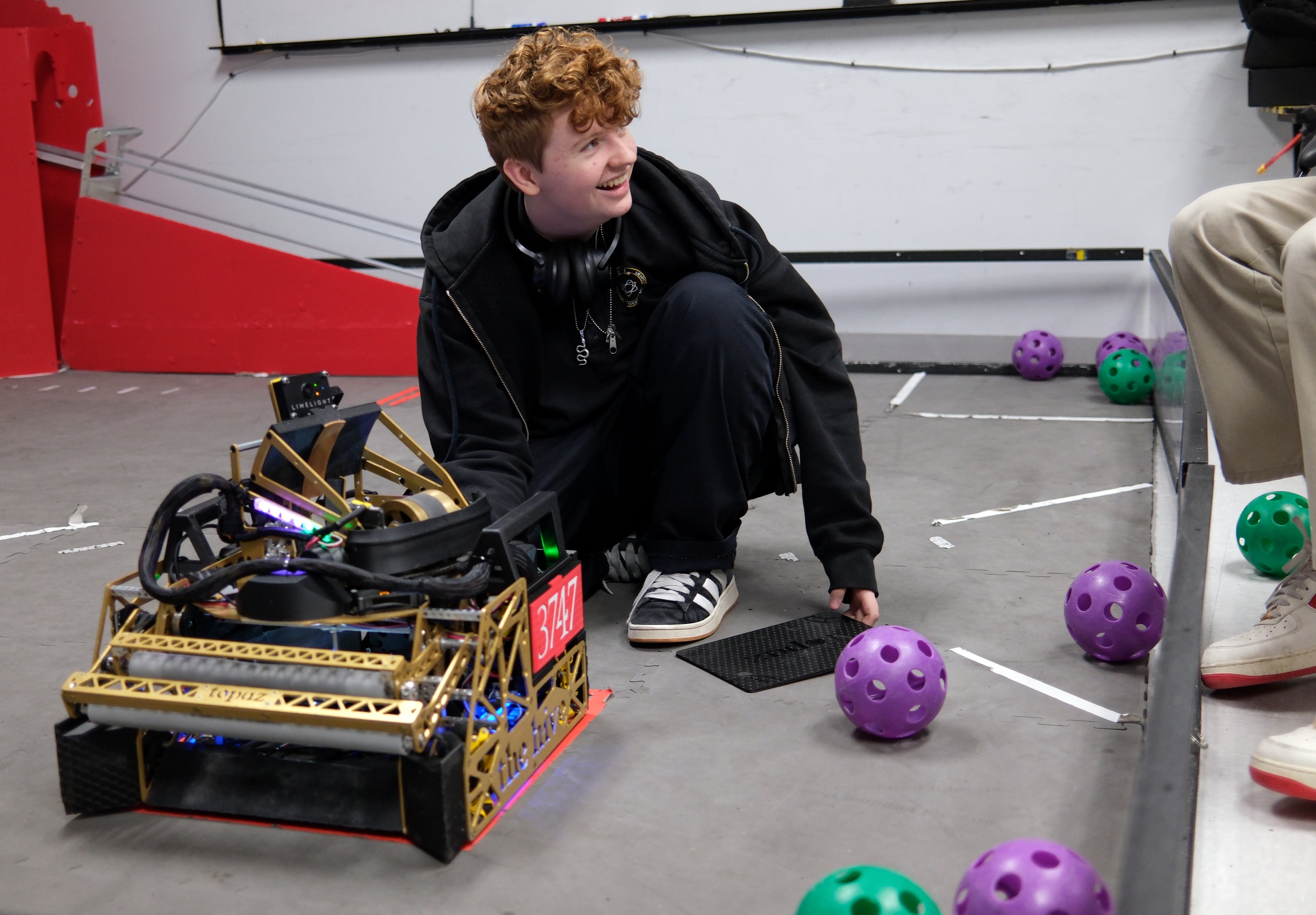 Dakota Drennan, high school junior, works with a robot named Topaz while practicing for the FIRST Tech Challenge robotics competition at Beehive Science and Technology Academy in Sandy on Thursday.