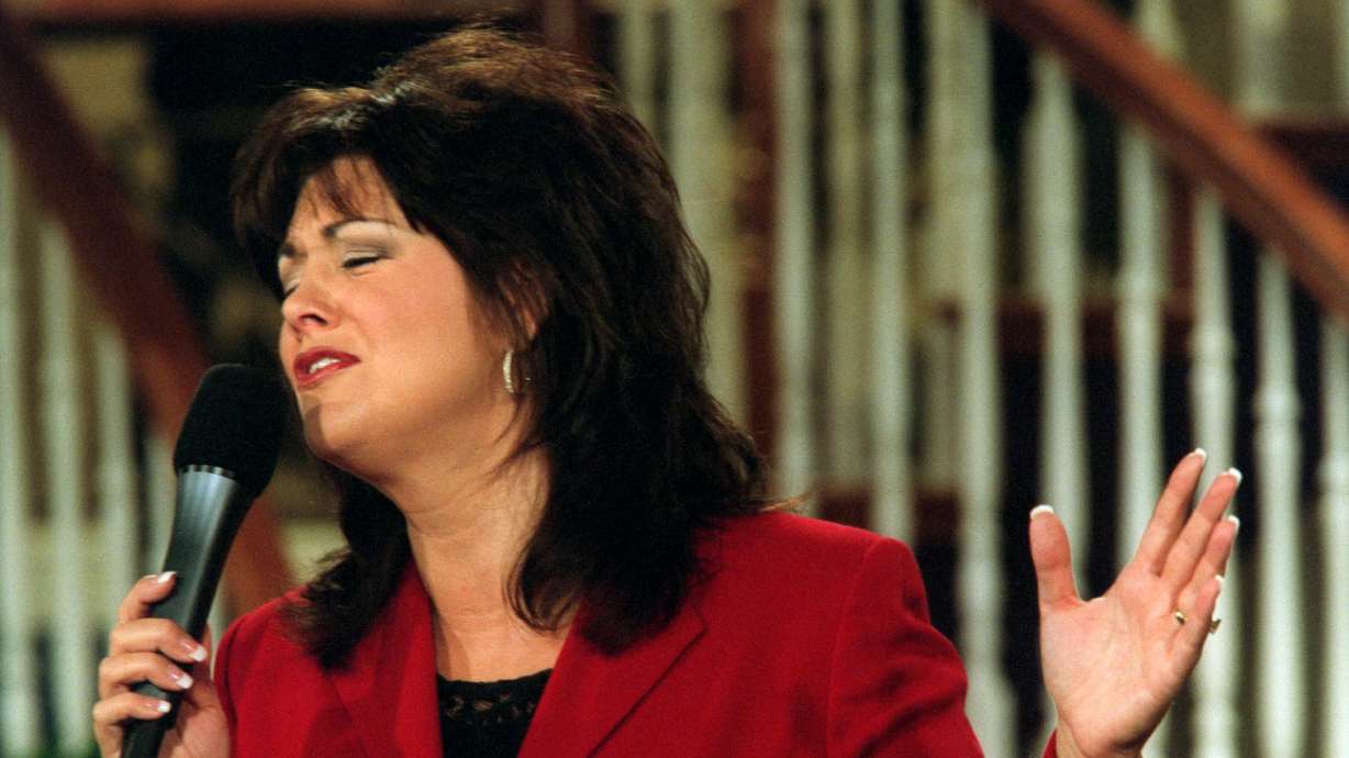 Television evangelist Joni Lamb sings a praise song during "Celebration," a show that she and her husband Marcus host on the Daystar Network, on July 30, 2001, in Colleyville, Texas. Lamb died on Thursday at the age of 65.