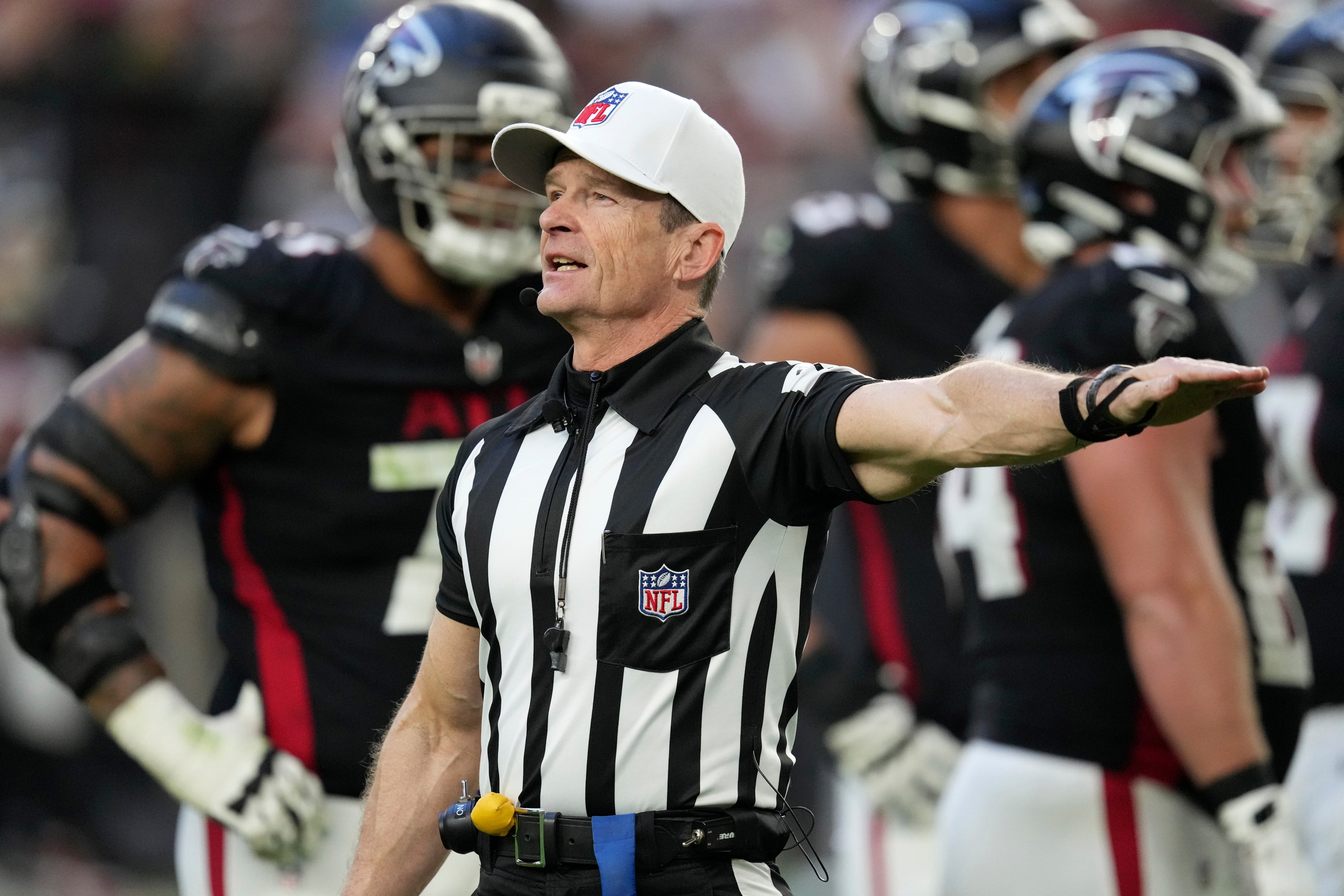FILE - Referee Land Clark annouces a penalty during the second half of an NFL football game between the Arizona Cardinals and the Atlanta Falcons Sunday, Dec. 21, 2025, in Glendale, Ariz.