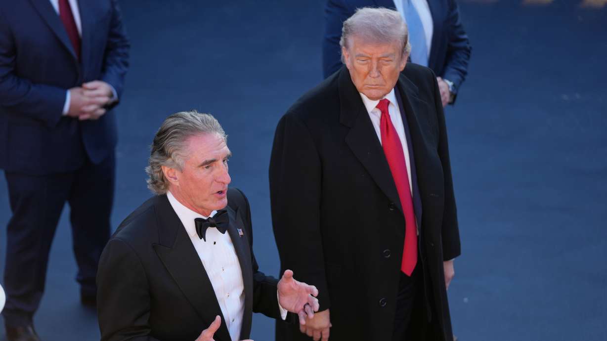 President Donald Trump listens as Interior Secretary Doug Burgum speaks at the Lincoln Memorial Reflecting Pool during a visit to to see the new blue protective coating being applied as part of a renovation project, Thursday in Washington.
