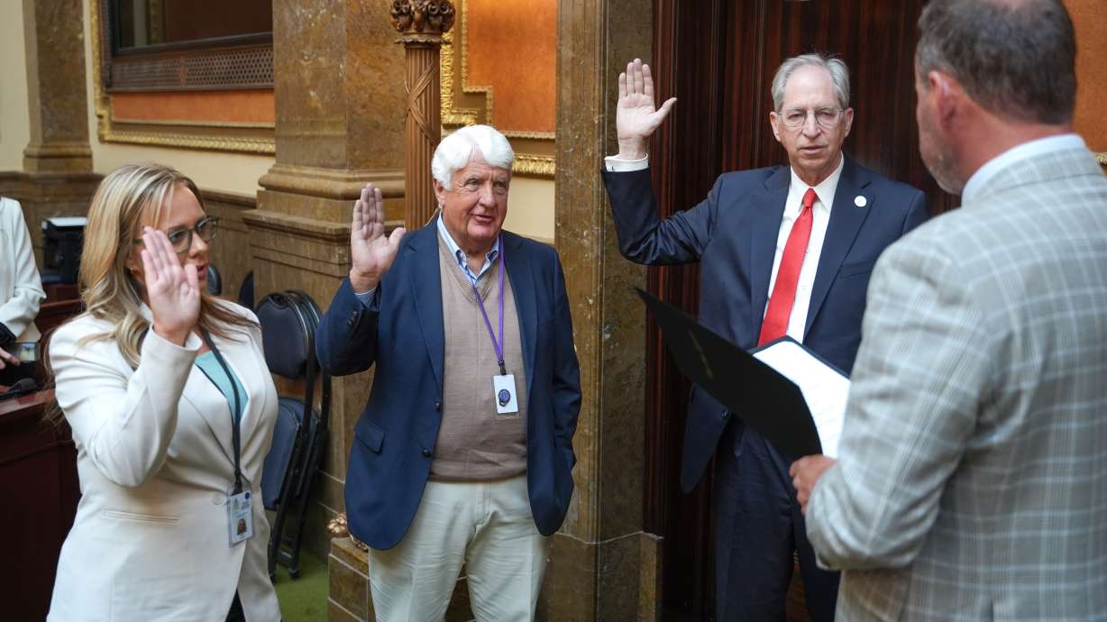 Reps. Jackie Larson, left, Rob Bishop and Grant Pace are sworn into the Utah House of Representatives by Speaker Mike Schultz at the Capitol in Salt Lake City on Wednesday.