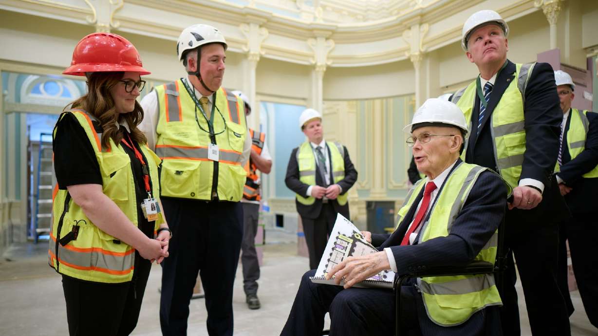 President Dallin H. Oaks of The Church of Jesus Christ of Latter-day Saints, seated right, tours the celestial room of the Salt Lake Temple on Friday in Salt Lake City.