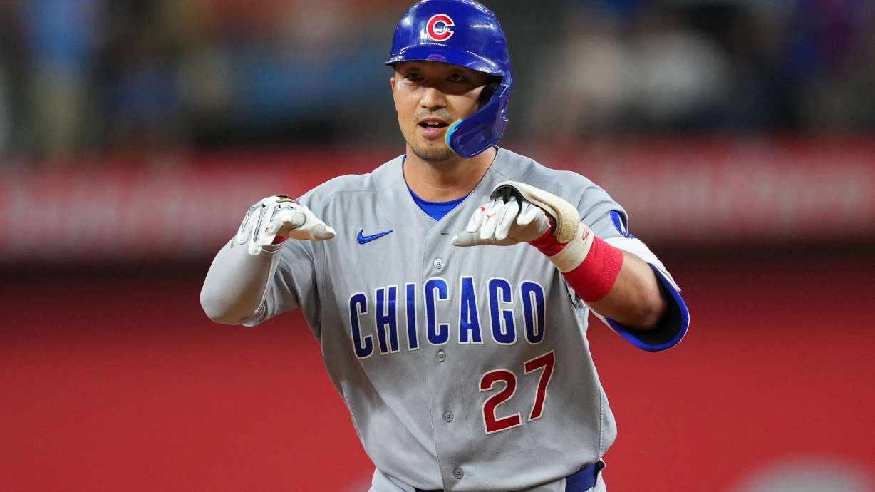 Chicago Cubs' Seiya Suzuki gestures while running the bases after hitting a two-run home run off Texas Rangers starting pitcher Kumar Rocker during the fourth inning of a baseball game Friday, May 8, 2026, in Arlington, Texas.