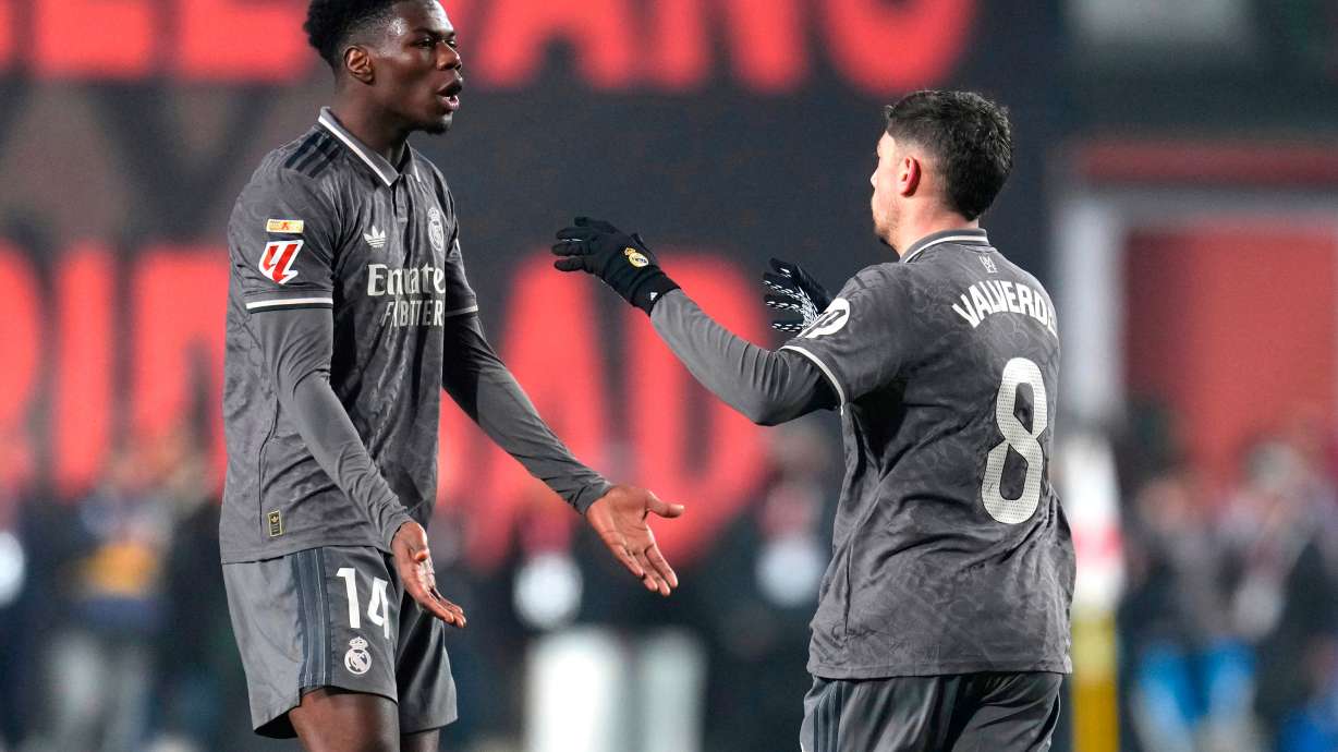 FILE - Real Madrid's Federico Valverde, right, celebrates with Aurelien Tchouameni after scoring his side's opening goal during the Spanish La Liga soccer match between Rayo Vallecano and Real Madrid at the Vallecas stadium in Madrid, Spain, Saturday, Dec. 14, 2024.