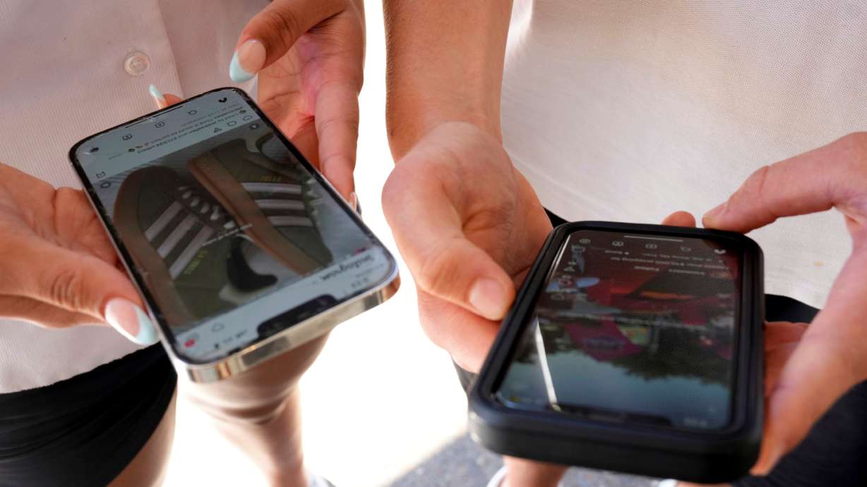 Young people use their phones to view social media in Sydney, Nov. 8, 2024. Australia and the United Kingdom both banned the use of social media by youth under 16, and the U.S. could soon follow.