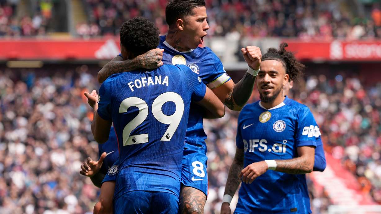 Chelsea's Enzo Fernandez (top) celebrates with team-mate Wesley Fofana after scoring their side's first goal of the game during the Premier League soccer match between Liverpool and Chelsea in Liverpool, England, Saturday, May 9, 2026.