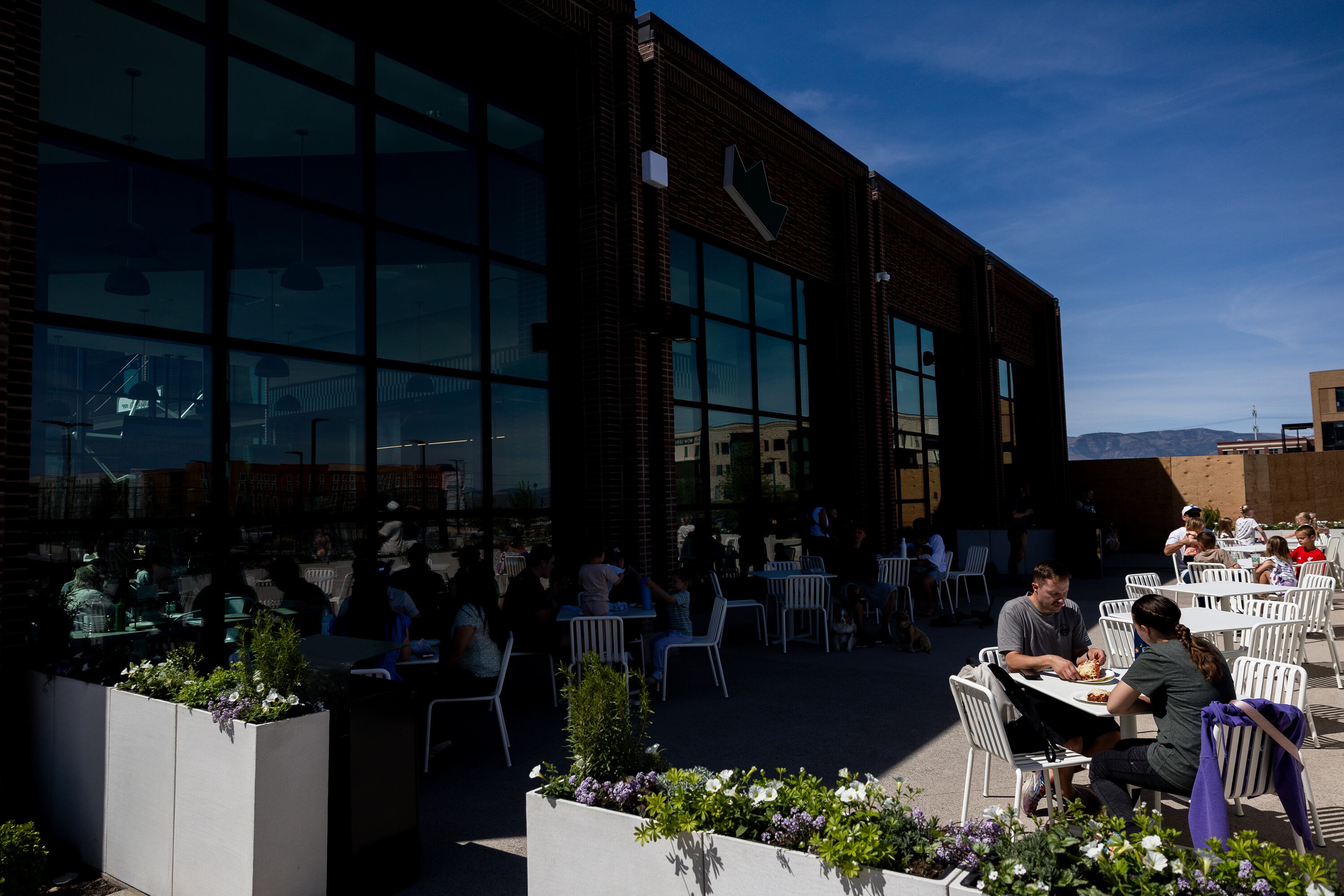 Customers enjoy their pizza on the patio at Fini Pizza in Vineyard during its grand opening on May 2. The New York-style pizzeria had quite a debut in just its first week.