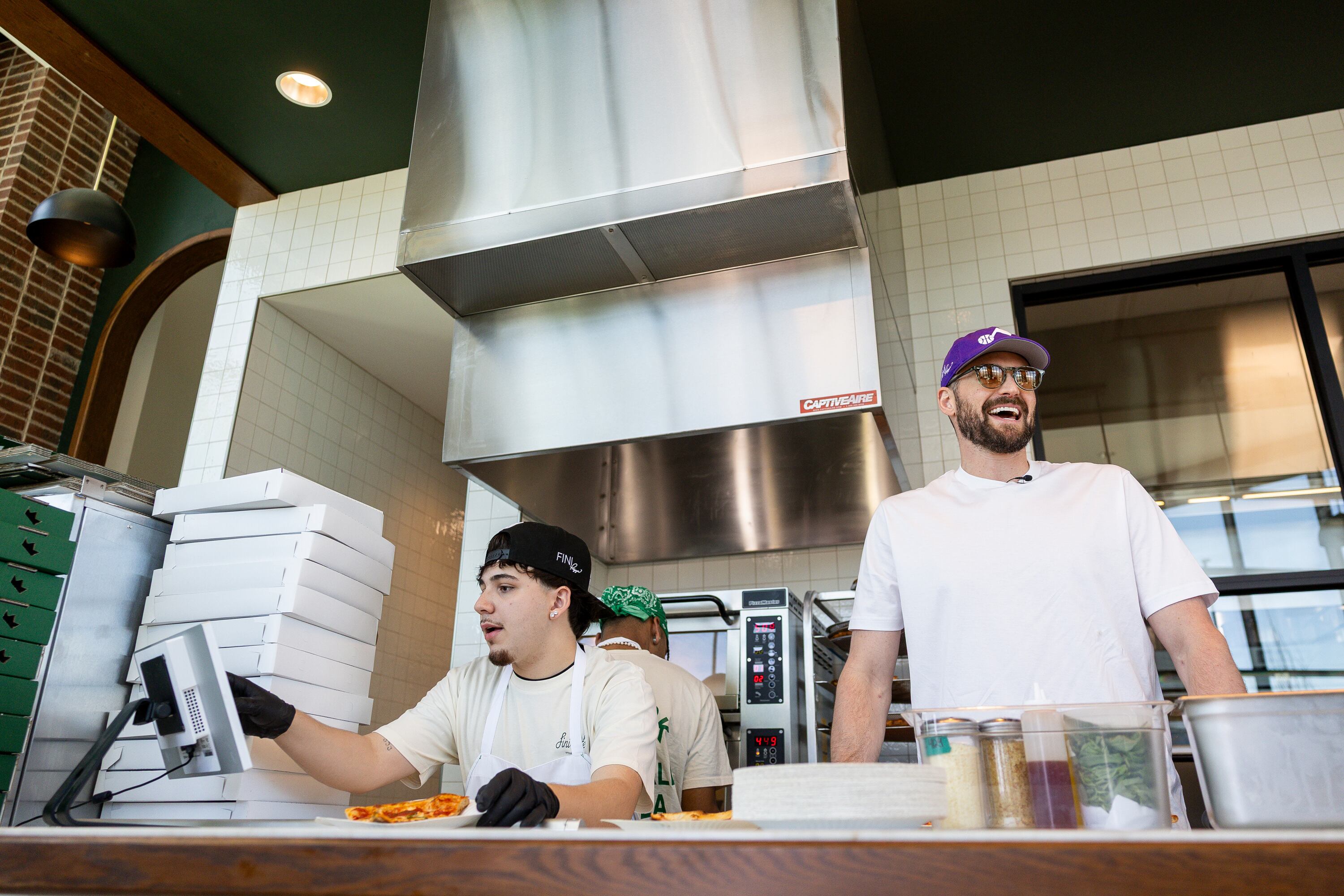 Utah Jazz forward Kevin Love yells out names on orders as helps out during the grand opening of Fini Pizza in Vineyard on May 2. Owner Sean Feeney's love of basketball permeates the restaurant, which will have its own basketball court soon.