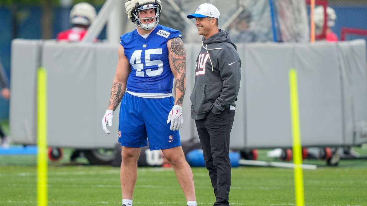 New York Giants head coach John Harbaugh, right, talks with New York Giants fullback Grant Finley, left, (45) at rookie minicamp at the NFL football team's practice facility, Saturday, May 9, 2026, in East Rutherford, N.J.