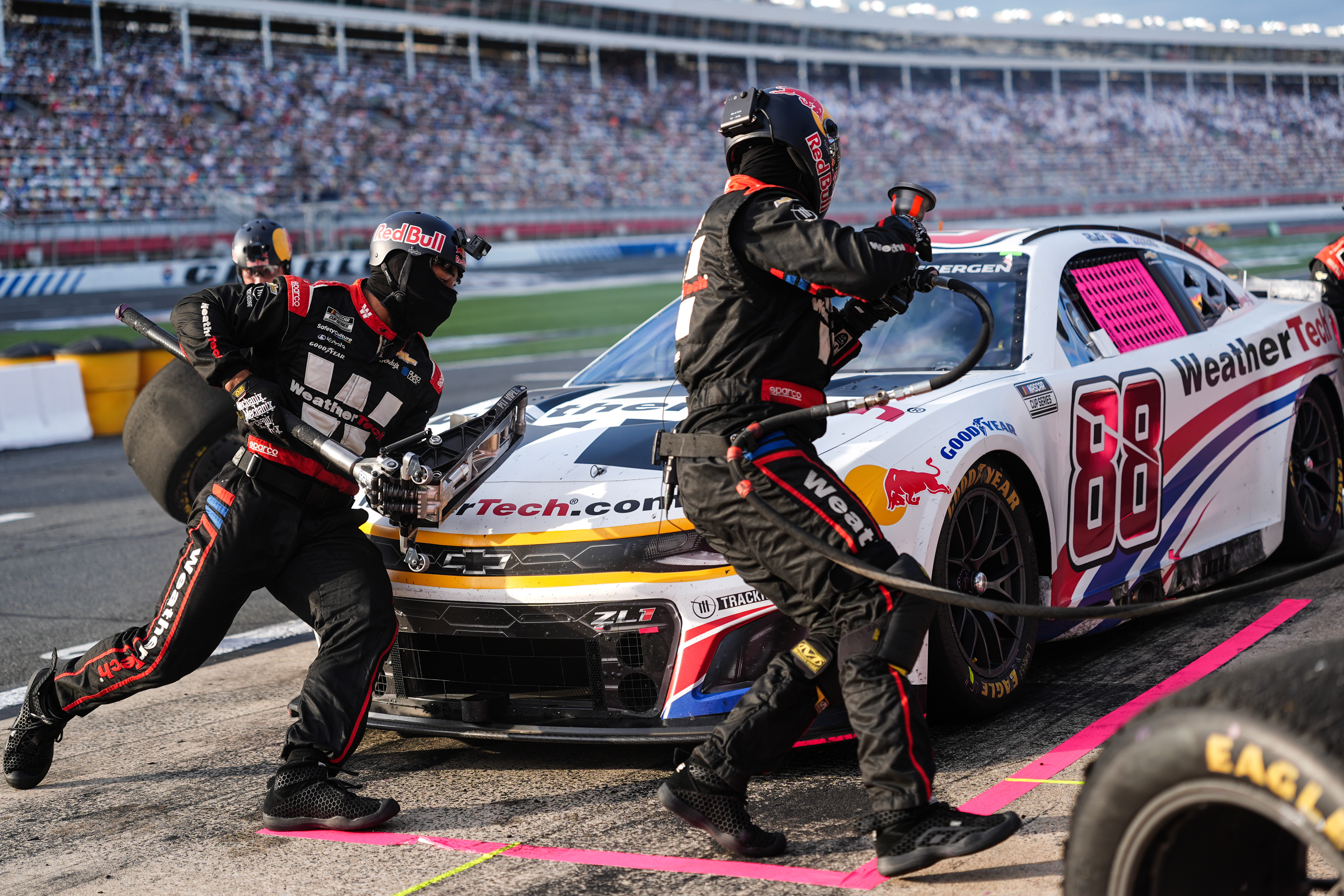 FILE - The pit crew for Shane van Gisbergen (88) rushes to complete a pit stop during a NASCAR Cup Series auto race at Charlotte Motor Speedway, Oct. 5, 2025, in Concord, N.C. 