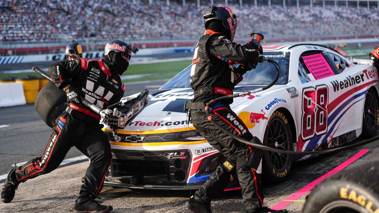 FILE - The pit crew for Shane van Gisbergen (88) rushes to complete a pit stop during a NASCAR Cup Series auto race at Charlotte Motor Speedway, Oct. 5, 2025, in Concord, N.C.