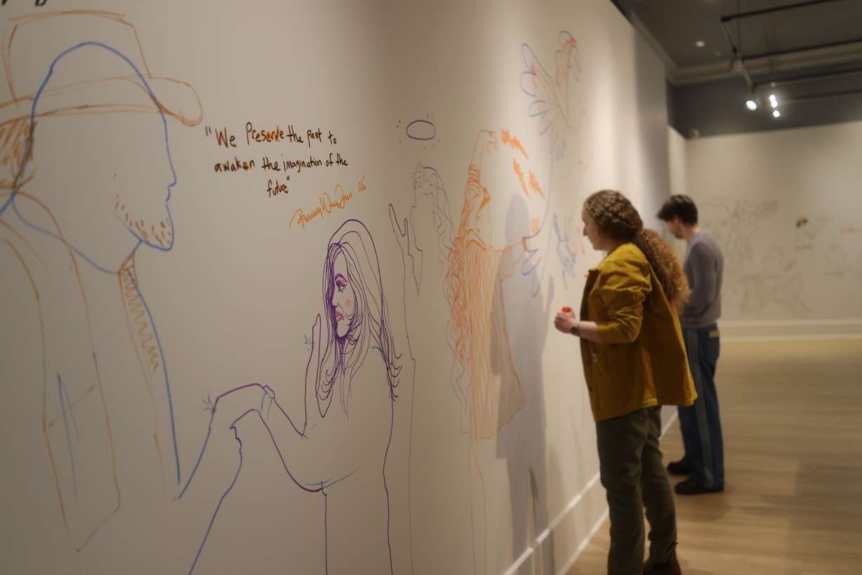 People participate in the "Make Your Mark" installation at the new Salt Lake Art Museum in Salt Lake City.