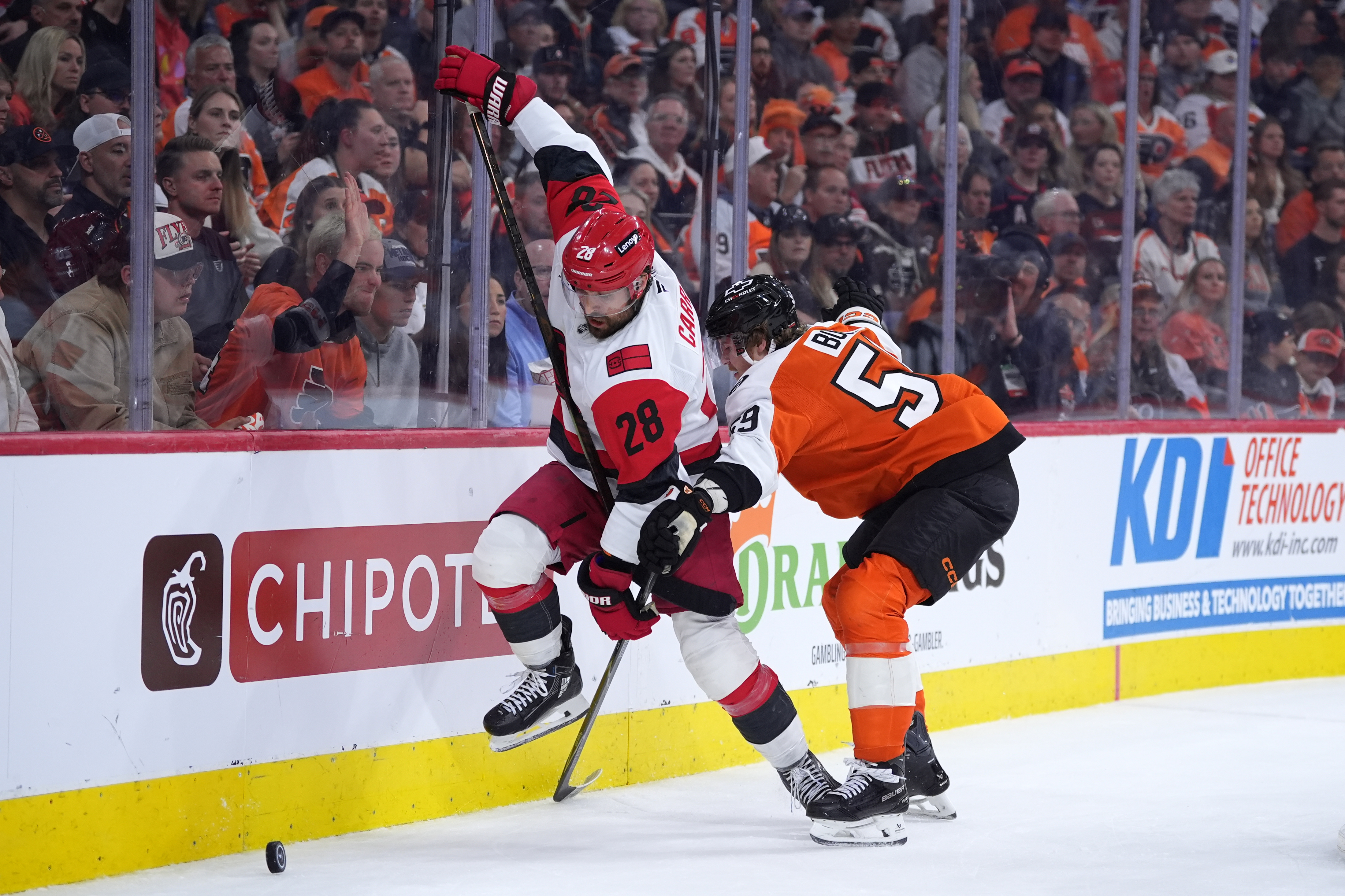 Carolina Hurricanes' William Carrier, left, tries to get past Philadelphia Flyers' Oliver Bonk, right, during the third period of Game 4 in a second-round NHL hockey Stanley Cup playoff series Saturday, May 9, 2026, in Philadelphia. 