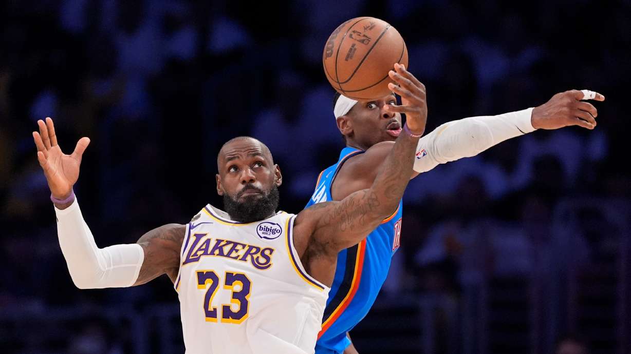 Los Angeles Lakers forward LeBron James, left, takes a pass as Oklahoma City Thunder guard Shai Gilgeous-Alexander defends during the first half of Game 3 in a second-round NBA basketball playoffs series Saturday, May 9, 2026, in Los Angeles.