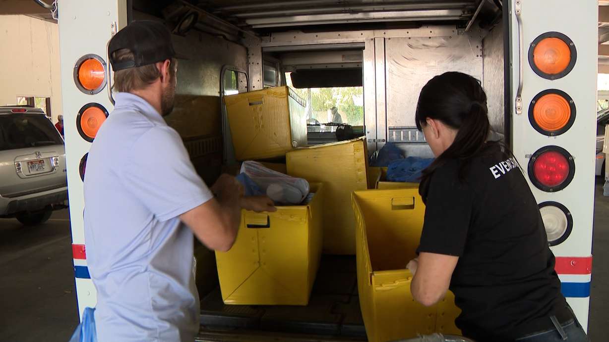 Mail carriers and volunteers for the Utah Food Bank unload and sort donations at the Sandy Post Office on Saturday. The Stamp Out Hunger Food Drive was one of the largest single-day drives in the country.