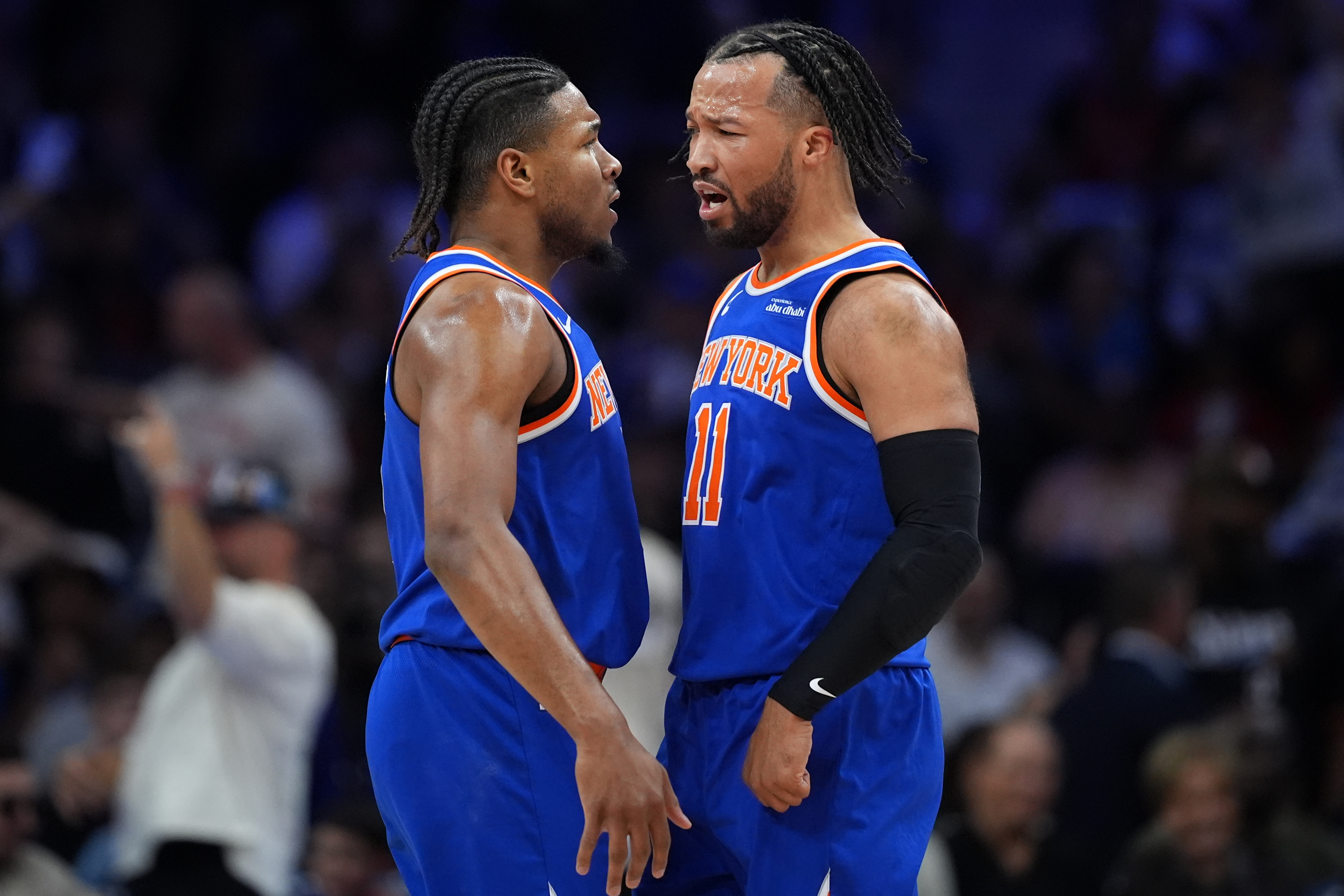 New York Knicks' Miles McBride, left, and Jalen Brunson celebrate during the first half of Game 4 against the Philadelphia 76ers in a second-round NBA basketball playoffs series Sunday, May 10, 2026, in Philadelphia. 