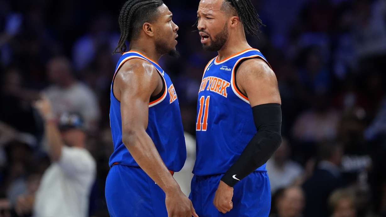 New York Knicks' Miles McBride, left, and Jalen Brunson celebrate during the first half of Game 4 against the Philadelphia 76ers in a second-round NBA basketball playoffs series Sunday, May 10, 2026, in Philadelphia.