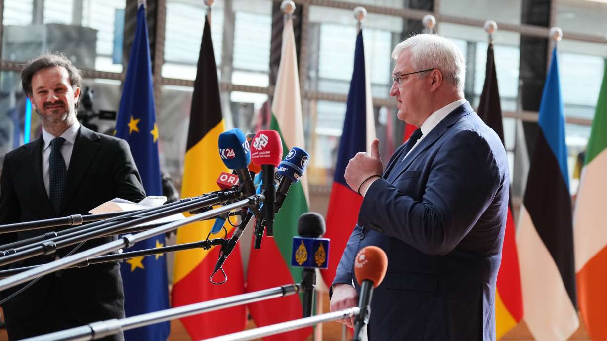 Ukraine's Foreign Minister Andrii Sybiha, right, speaks with the media as he arrives for a meeting of EU foreign ministers at the European Council building in Brussels on Monday.