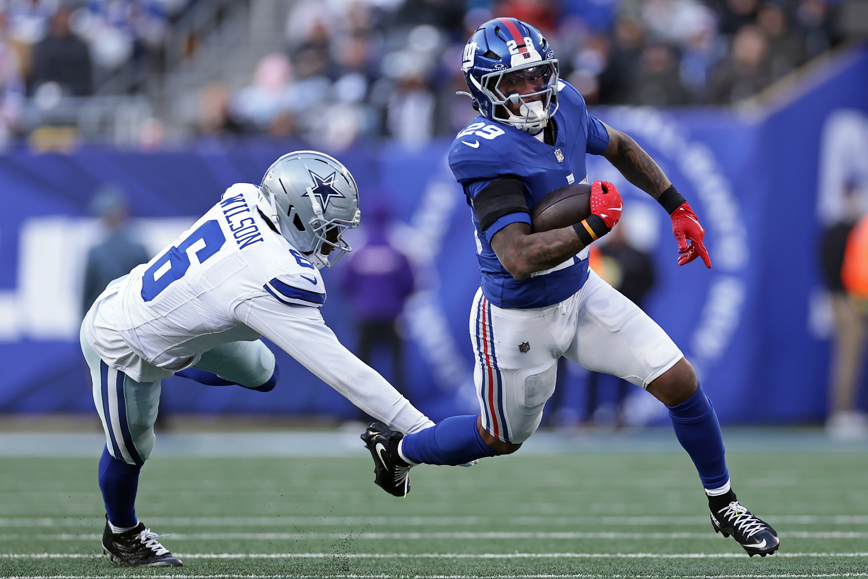 FILE - New York Giants running back Tyrone Tracy Jr. (29) runs with the ball past Dallas Cowboys safety Donovan Wilson (6) during an NFL football game on Jan. 4, 2026, in East Rutherford, N.J.