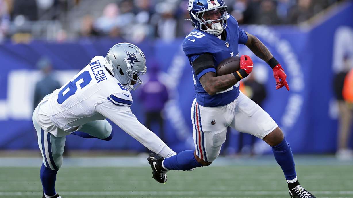 FILE - New York Giants running back Tyrone Tracy Jr. (29) runs with the ball past Dallas Cowboys safety Donovan Wilson (6) during an NFL football game on Jan. 4, 2026, in East Rutherford, N.J.