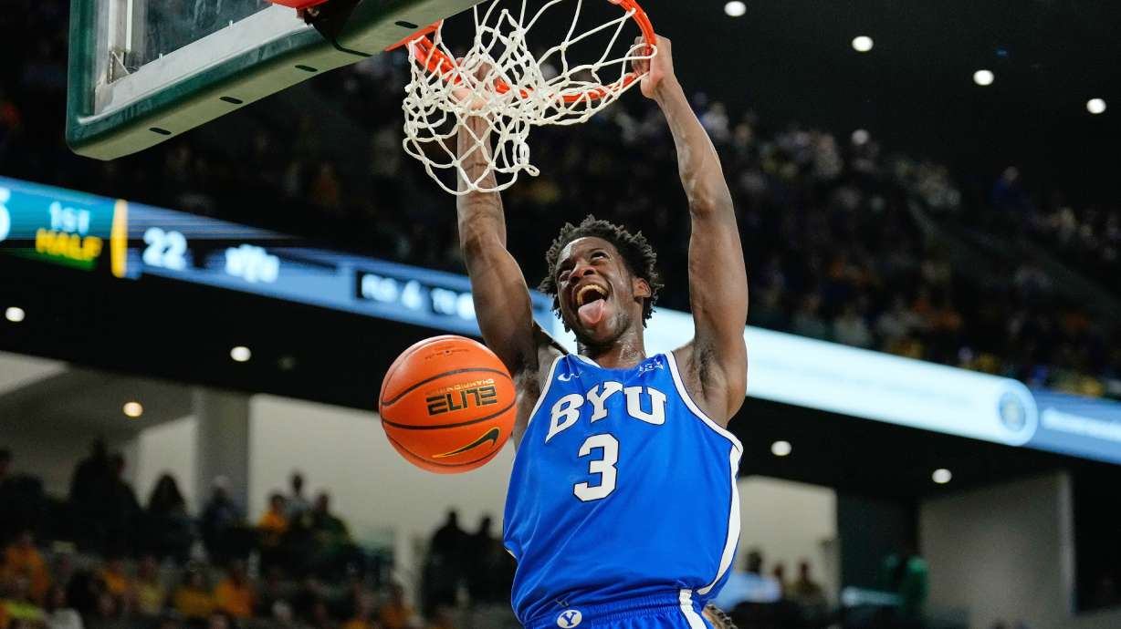 FILE - BYU forward AJ Dybantsa dunks in the first half of an NCAA college basketball game against Baylor Tuesday, Feb. 10, 2026, in Waco, Texas. (AP Photo/Tony Gutierrez, File