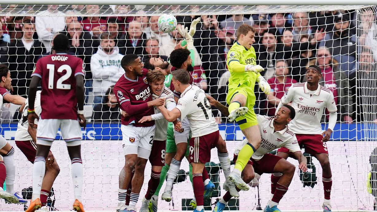 Arsenal goalkeeper David Raya, center, is fouled by West Ham United's Pablo Felipe in the build up to Callum Wilson disallowed goal during the English Premier League match in London, Sunday May 10, 2026.