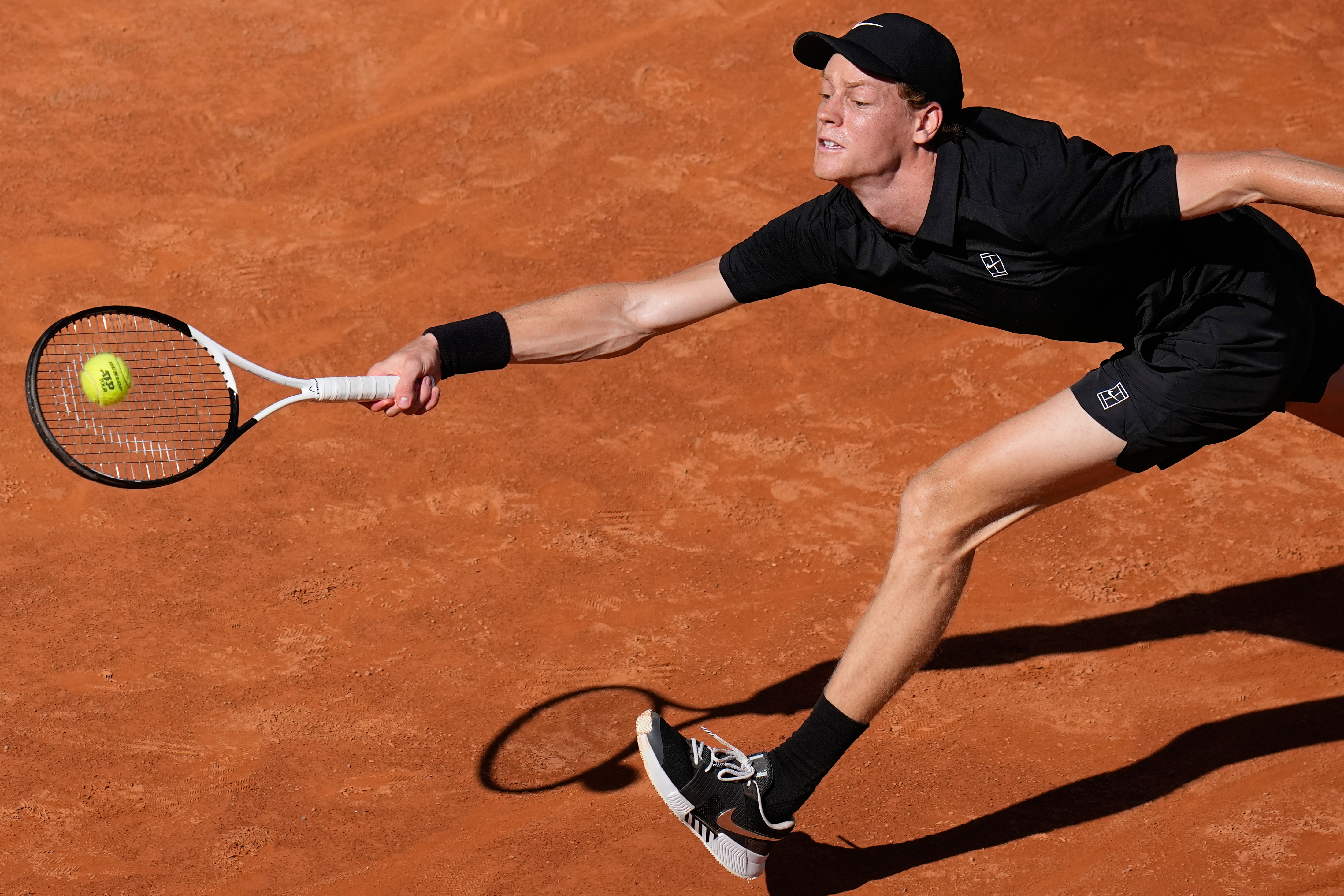 Italy's Jannik Sinner stretches to return the ball to Australia's Alexei Popyrin, during their match at the Italian Open tennis tournament in Rome, Monday, May 11, 2026.