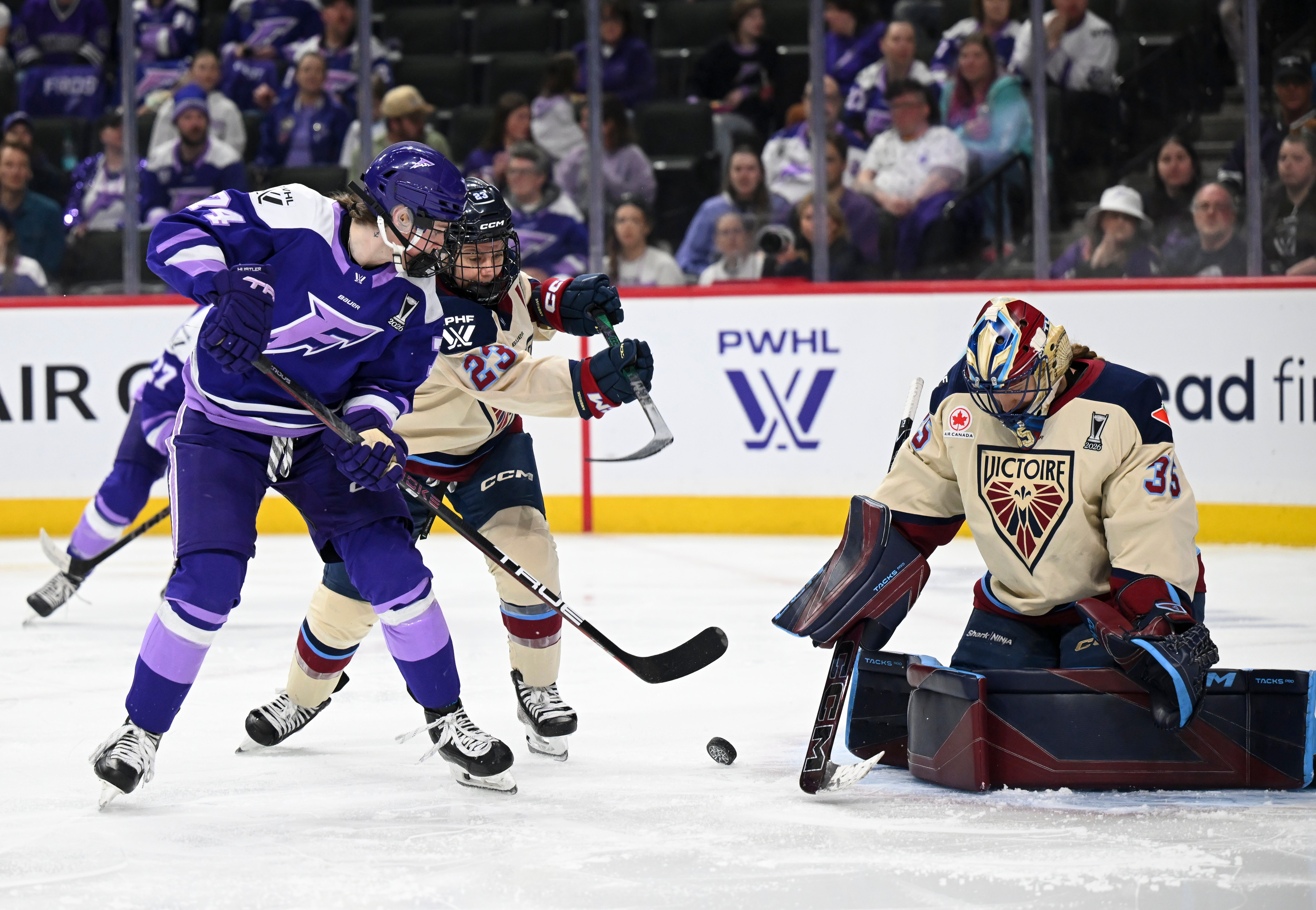 Minnesota Frost forward Abby Hustler (74) attacks the goal of Montreal Victoire goaltender Ann-Renée Desbiens (35) in the second period of a Game 4 in a PWHL hockey playoff series game, Friday, May 8, 2026, in St. Paul, Minn. 