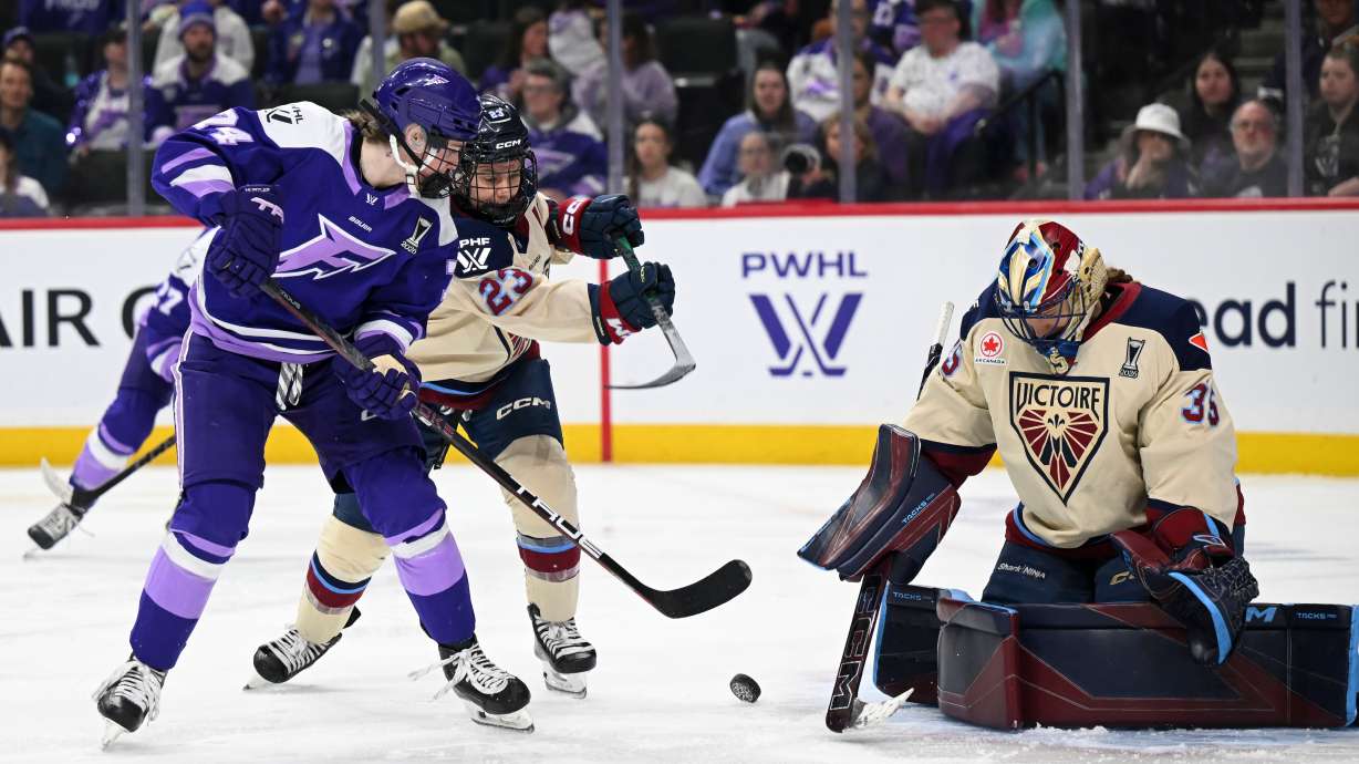 Minnesota Frost forward Abby Hustler (74) attacks the goal of Montreal Victoire goaltender Ann-Renée Desbiens (35) in the second period of a Game 4 in a PWHL hockey playoff series game, Friday, May 8, 2026, in St. Paul, Minn.