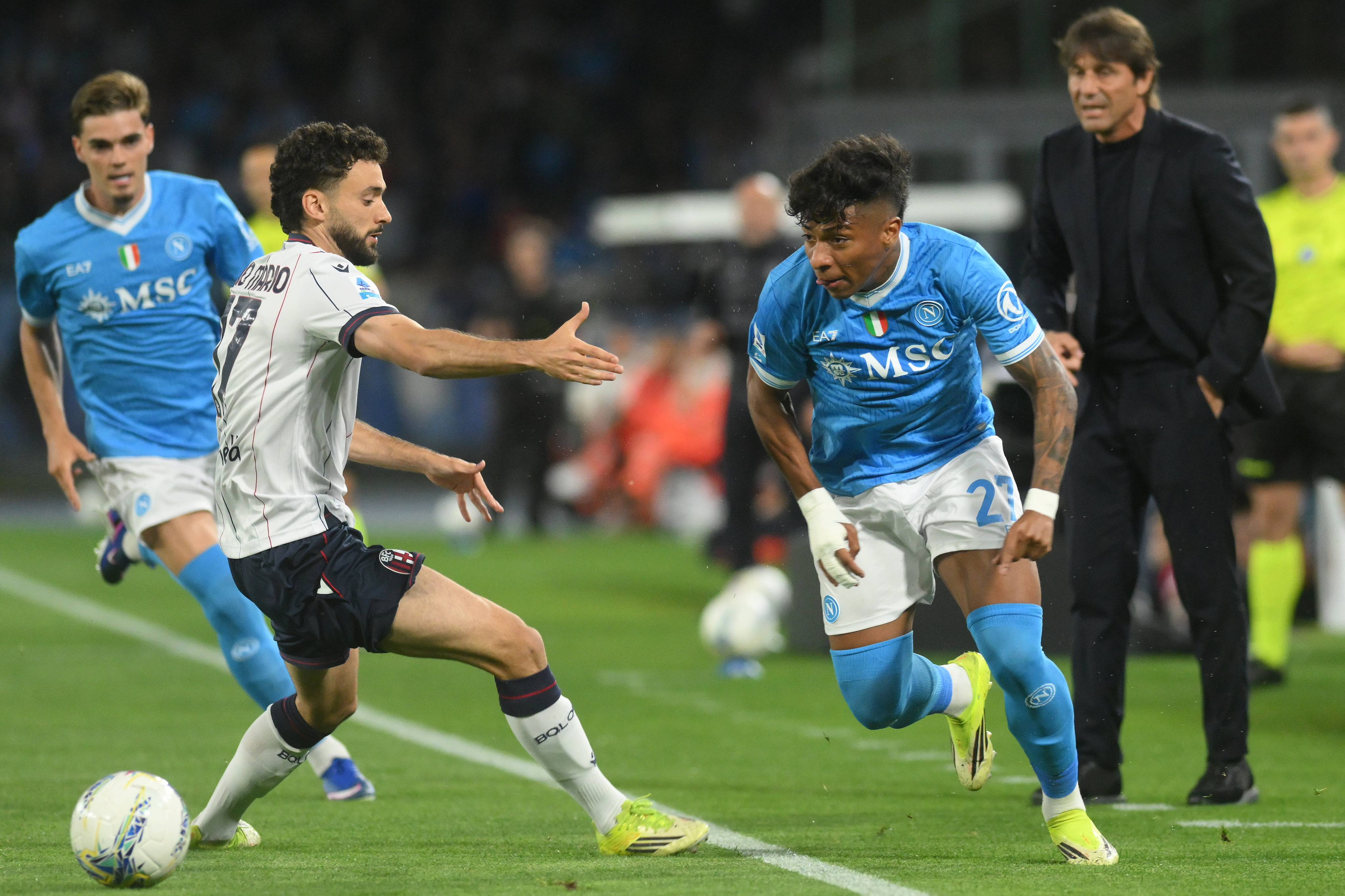 Bologna's Joao Pedro, second left, challenges for the ball with Napoli's Alisson Santos during the Italian Serie A soccer match between Napoli and Bologna in Naples, Italy, Monday, May 11, 2026. 