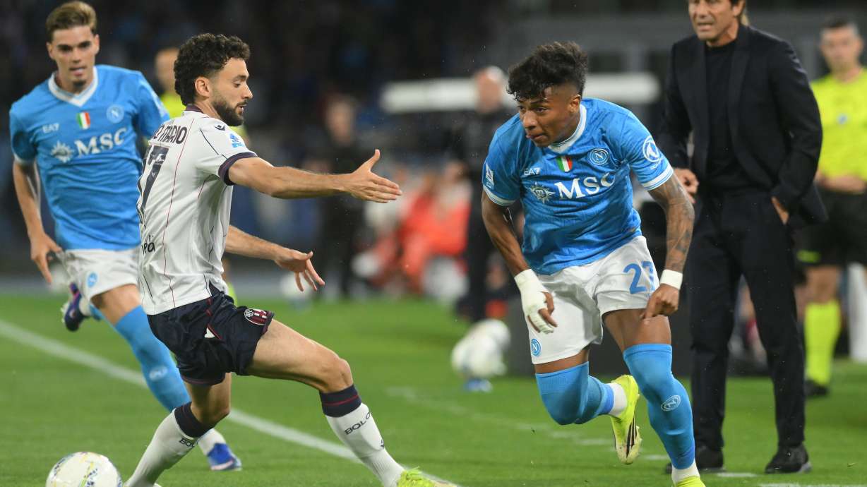 Bologna's Joao Pedro, second left, challenges for the ball with Napoli's Alisson Santos during the Italian Serie A soccer match between Napoli and Bologna in Naples, Italy, Monday, May 11, 2026.