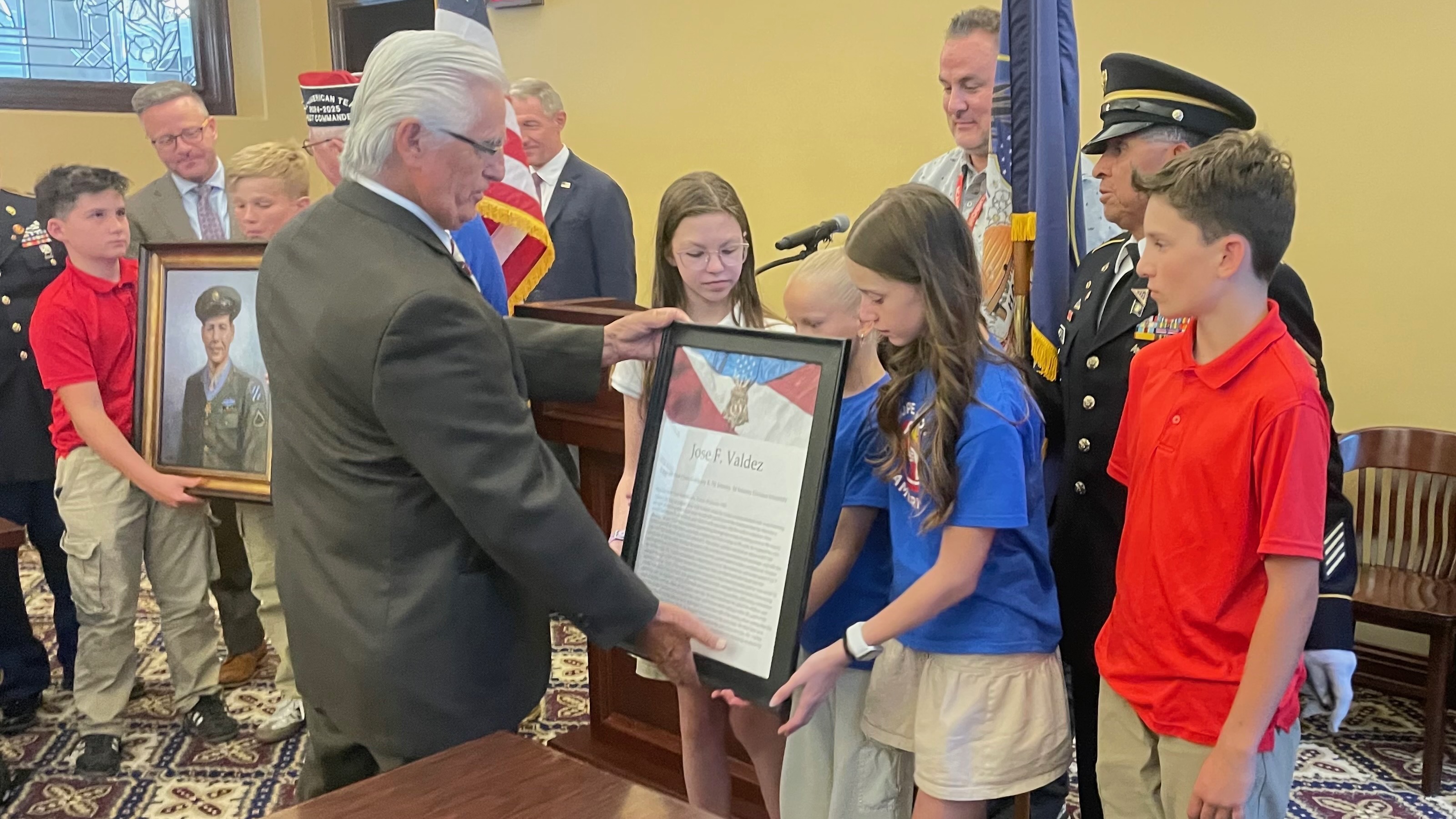 Boosters of Army Pfc. Jose Valdez, a Medal of Honor recipient, seeks homes for the remaining seven prints of the man. Johnny Martinez, left, one of Valdez's relatives, and others gathered at the Capitol in Salt Lake City on Monday to promote the effort.