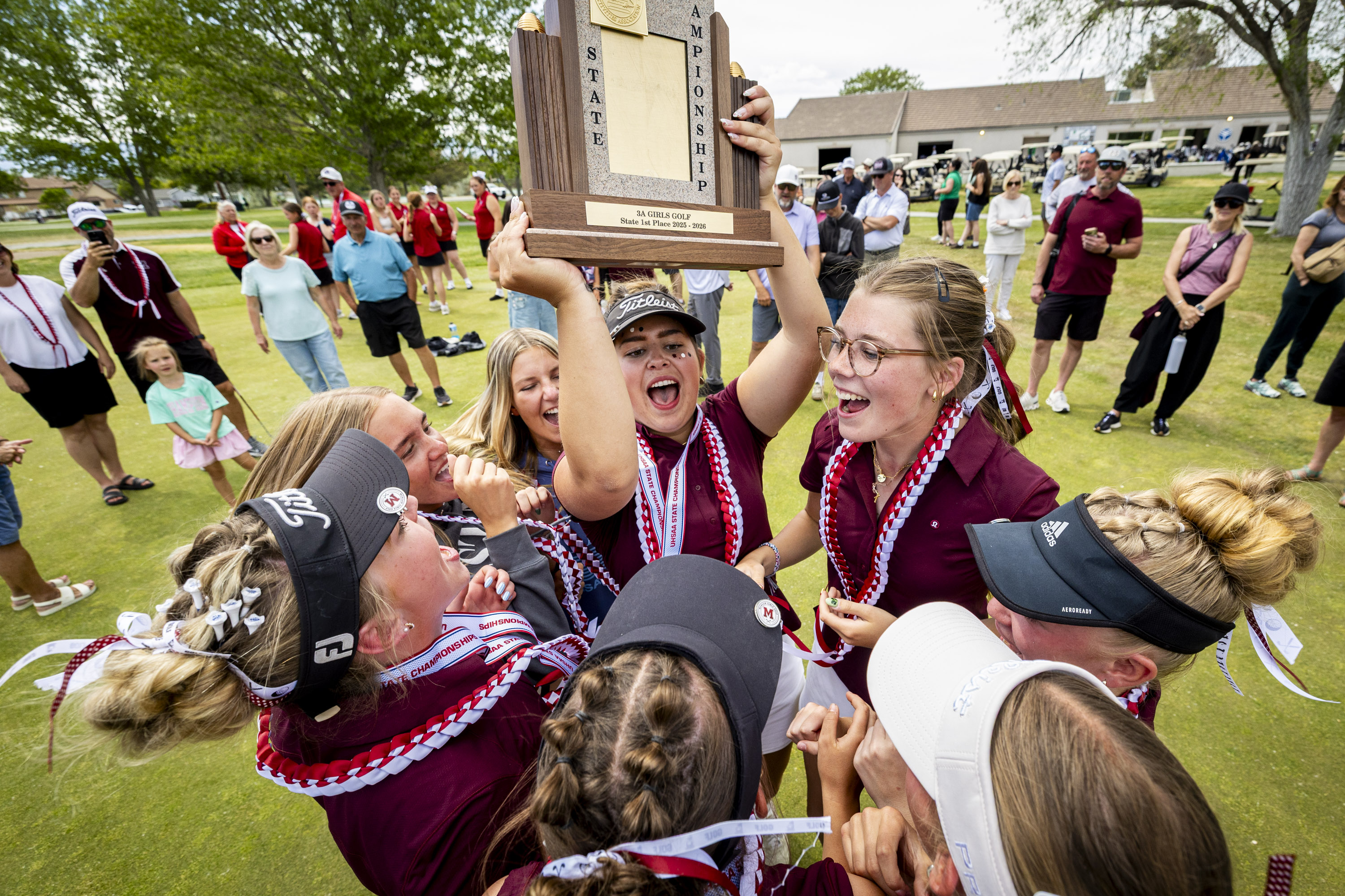 Morgan’s Kenadee Benson cheers with her teammates as she holds the team championship trophy after the final round of the 3A girls golf state championship held at the Stansbury Park Golf Course on Thursday, May 7, 2026. Benson won the individual championship in addition to Morgan’s first-place team victory.